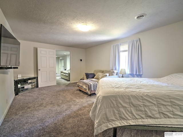 carpeted bedroom featuring a textured ceiling