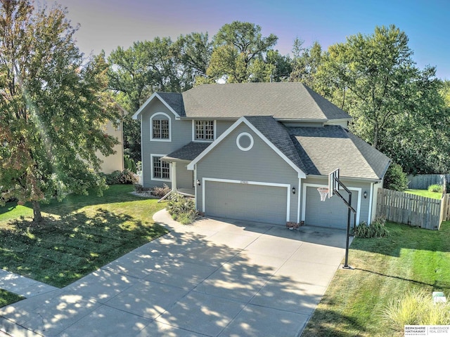 view of property with a yard and a garage