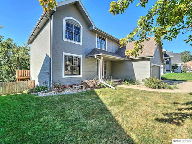 front of property with a garage and a front lawn