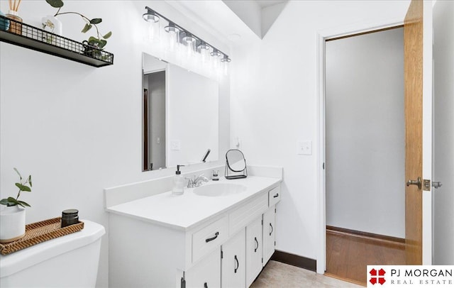 bathroom featuring vanity and toilet