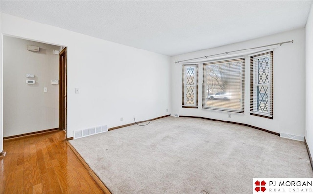 spare room with a textured ceiling