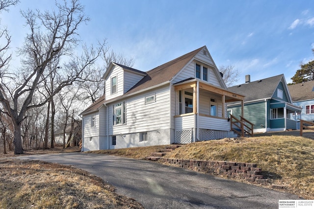 view of side of home featuring a porch