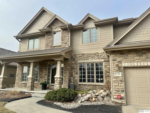 craftsman-style home with a garage and covered porch