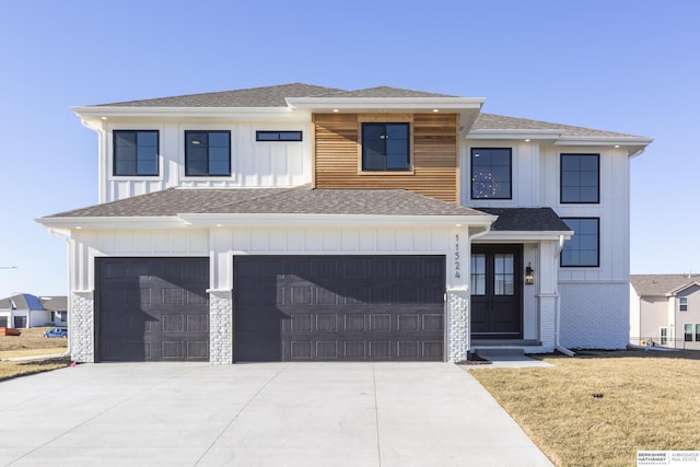 view of front of house with a garage and a front lawn