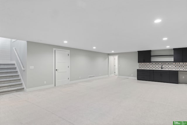 unfurnished living room with stairs, recessed lighting, visible vents, and light colored carpet