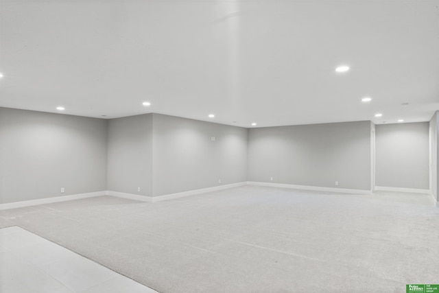 finished below grade area with recessed lighting, light carpet, and baseboards