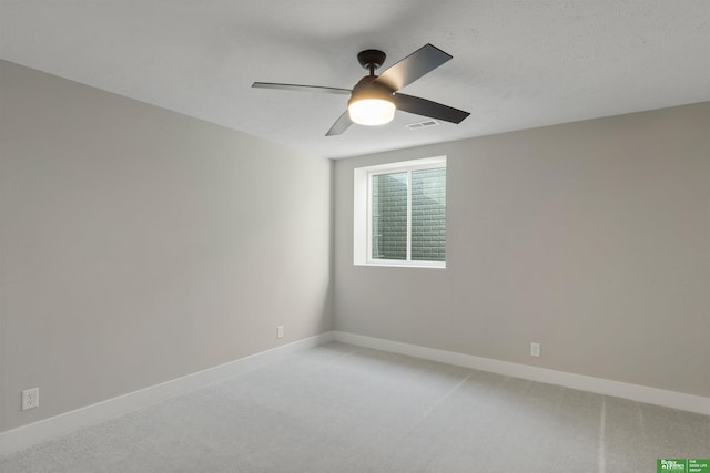 unfurnished room with visible vents, baseboards, and light colored carpet