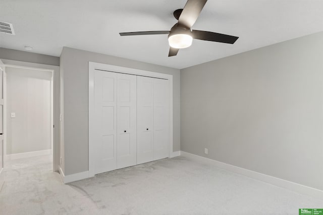 unfurnished bedroom featuring baseboards, visible vents, ceiling fan, carpet floors, and a closet