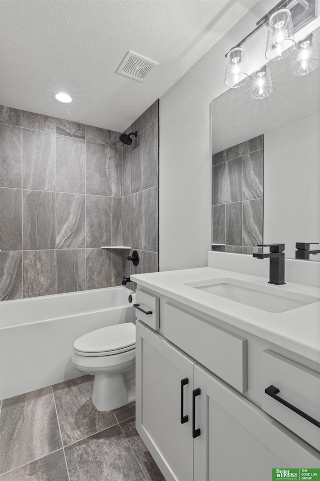 bathroom with visible vents, bathing tub / shower combination, toilet, a textured ceiling, and vanity