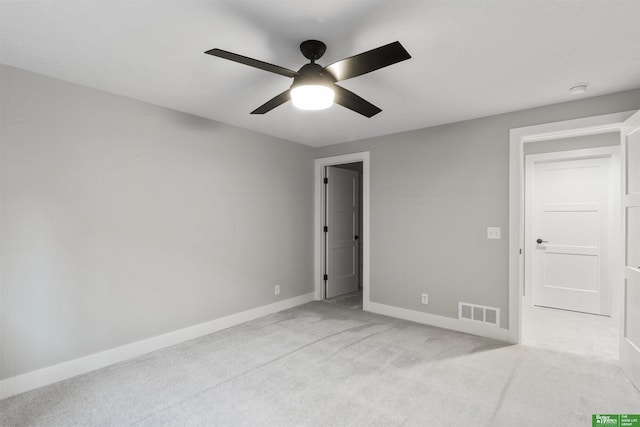 unfurnished bedroom with a ceiling fan, visible vents, light carpet, and baseboards