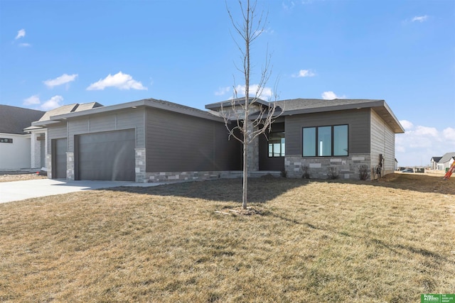 view of front of property with stone siding, concrete driveway, an attached garage, and a front yard