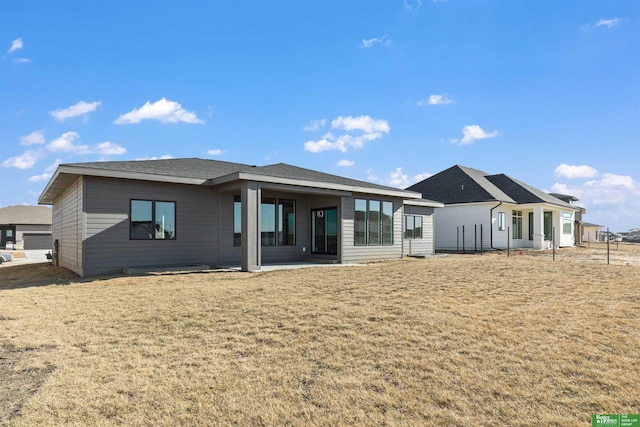 back of house featuring a yard