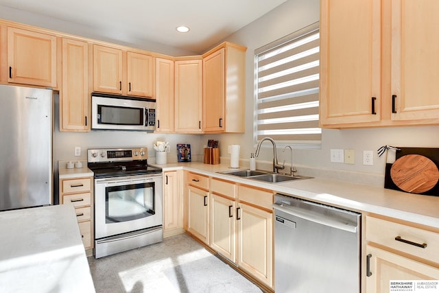 kitchen with stainless steel appliances, sink, and light brown cabinets