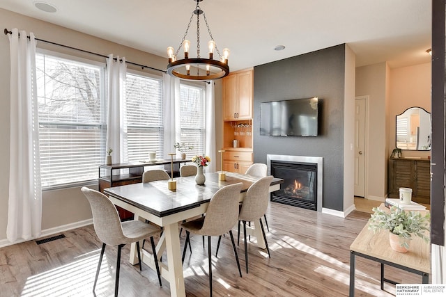 dining area featuring a notable chandelier and light hardwood / wood-style floors