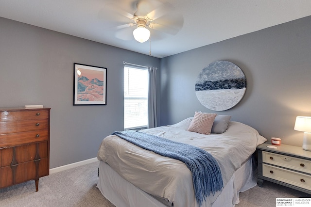 bedroom featuring light colored carpet and ceiling fan