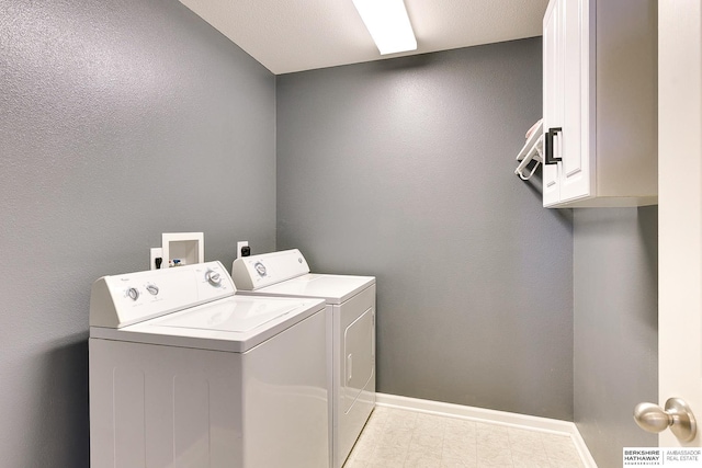 washroom featuring washing machine and dryer and cabinets