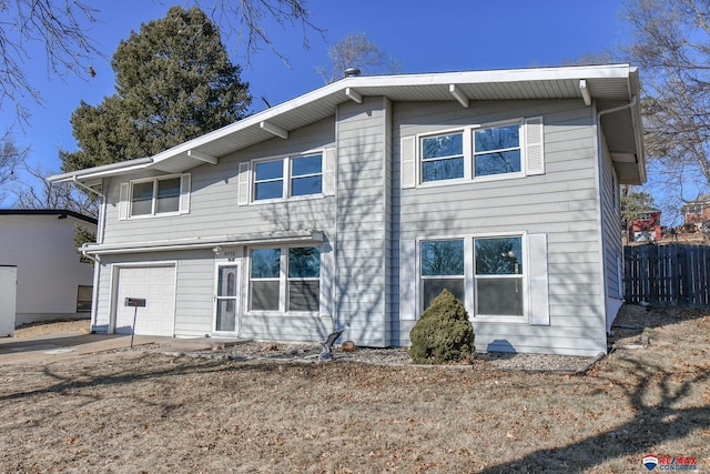 rear view of house featuring a garage