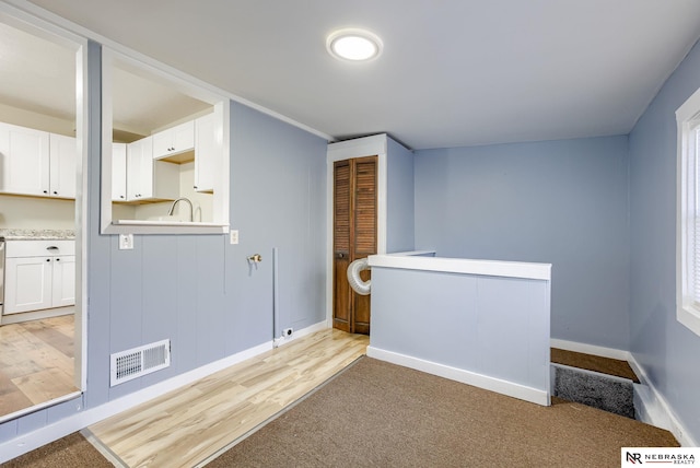 interior space featuring white cabinetry and light hardwood / wood-style flooring