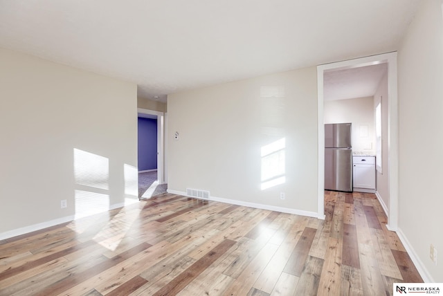 spare room featuring light hardwood / wood-style flooring