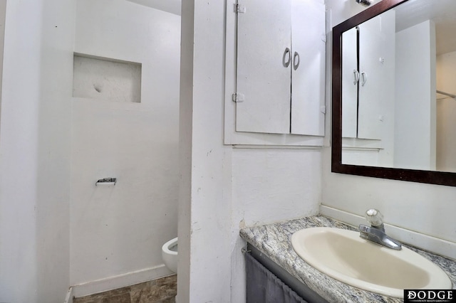 bathroom featuring vanity and toilet