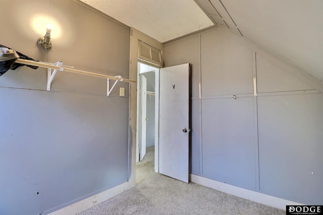 interior space featuring light colored carpet and vaulted ceiling