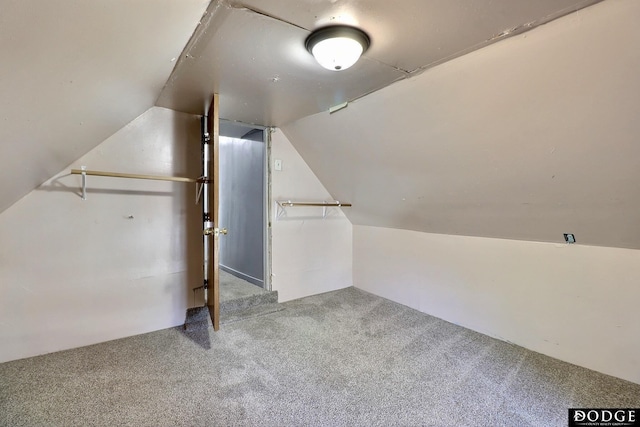 bonus room featuring lofted ceiling and carpet flooring