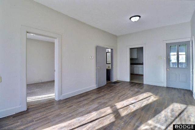 unfurnished living room with dark hardwood / wood-style floors