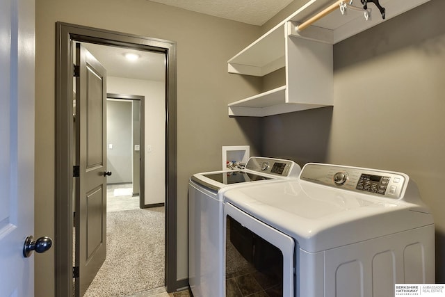 laundry room featuring light carpet and washer and clothes dryer