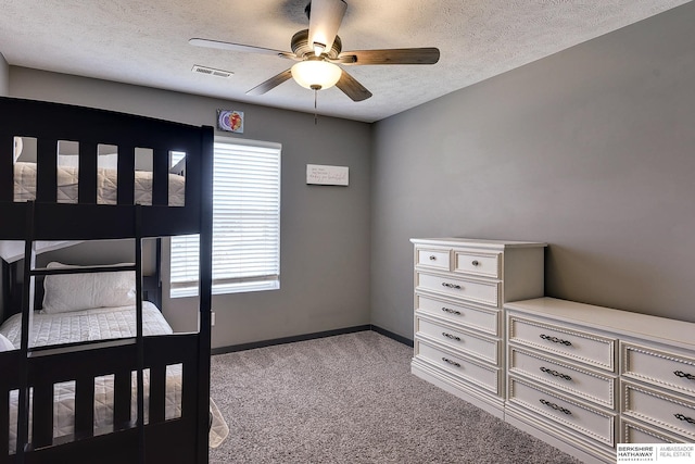 bedroom featuring ceiling fan, light carpet, and a textured ceiling