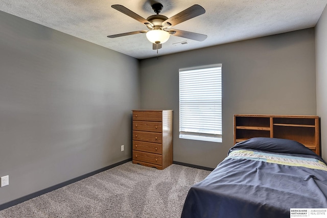 unfurnished bedroom with ceiling fan, carpet floors, and a textured ceiling