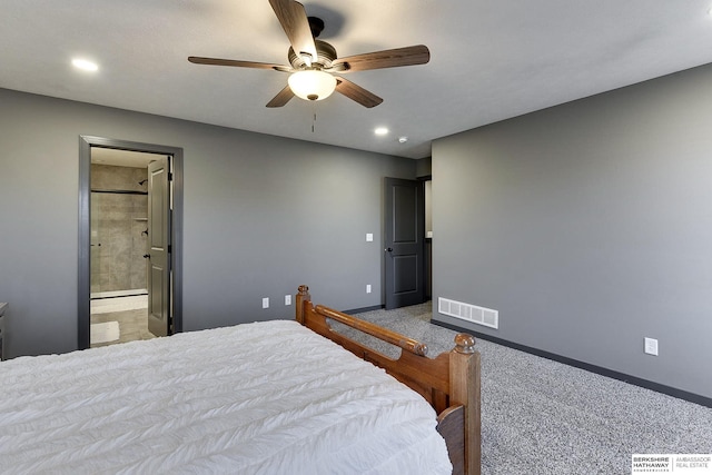 carpeted bedroom with ensuite bath and ceiling fan