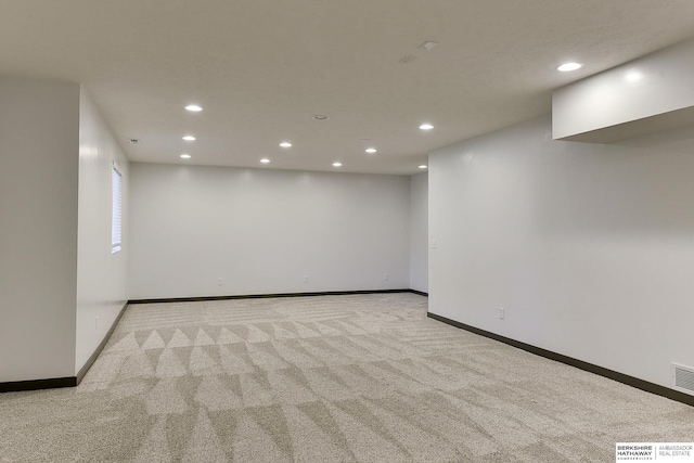 empty room featuring light carpet