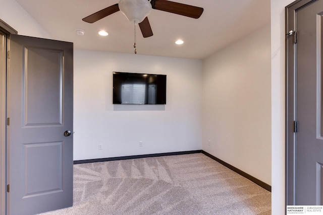 spare room with light colored carpet and ceiling fan