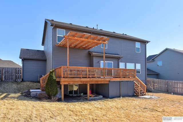 back of house with a wooden deck and a lawn