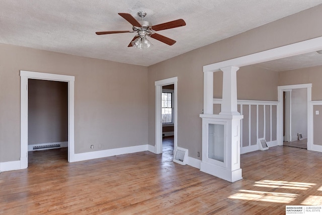 spare room featuring visible vents, a textured ceiling, and light wood finished floors