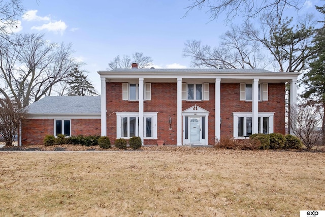 greek revival house featuring a front yard