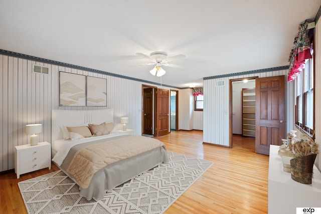 bedroom featuring crown molding, hardwood / wood-style flooring, and ceiling fan