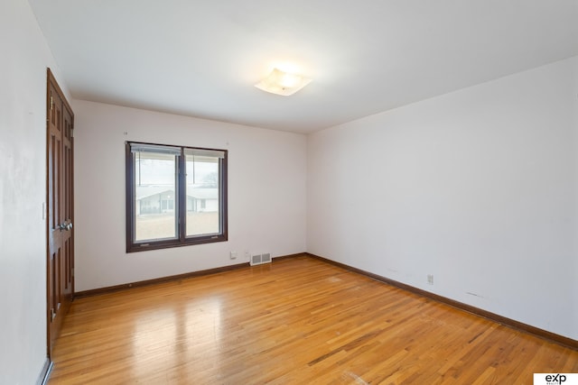 unfurnished room with light hardwood / wood-style floors