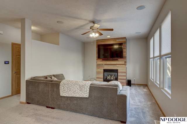 carpeted living room featuring a textured ceiling and ceiling fan