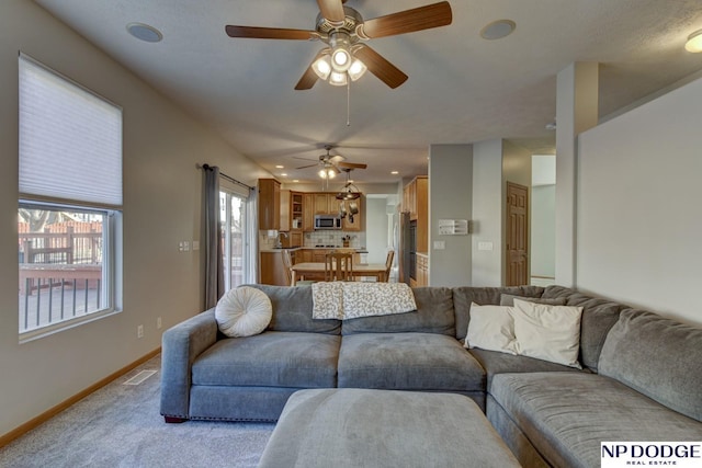 living room with sink and light colored carpet