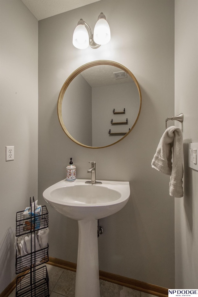 bathroom with a textured ceiling