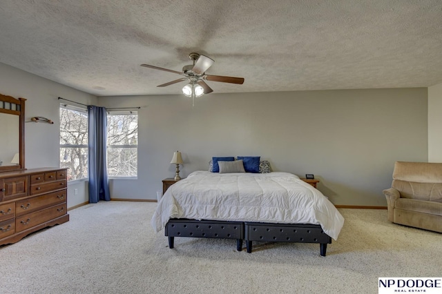 carpeted bedroom with ceiling fan and a textured ceiling