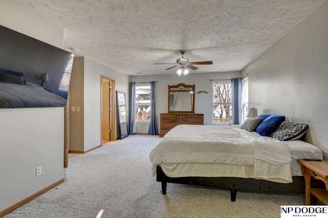 carpeted bedroom with ceiling fan and a textured ceiling