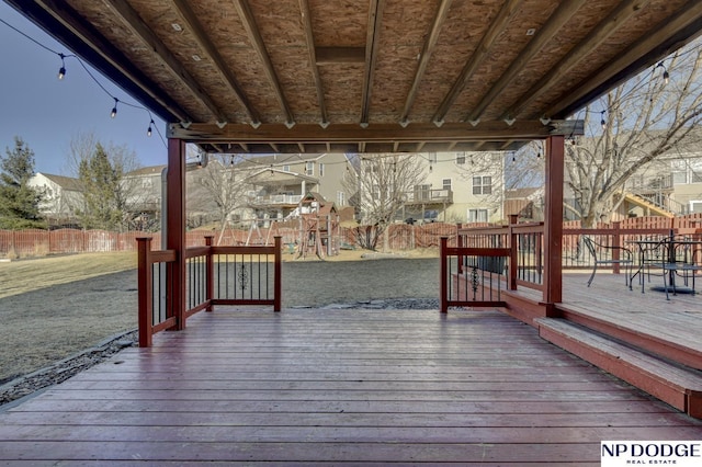 deck featuring a playground and a yard