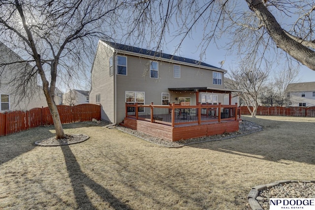 back of house with a yard and a deck