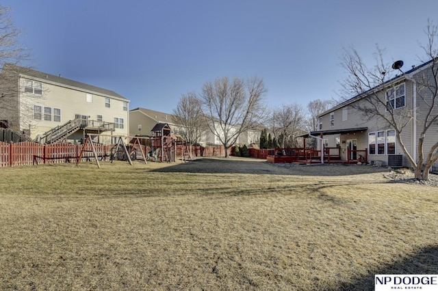 view of yard featuring central AC unit and a playground