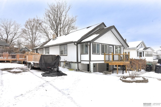 snow covered property featuring a deck