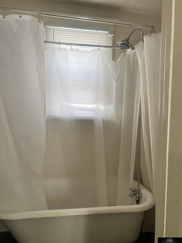 bathroom with a bathtub and curtained shower