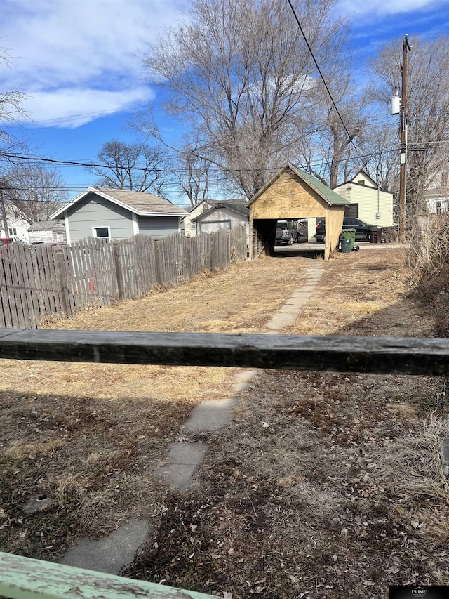 view of yard with a carport and fence