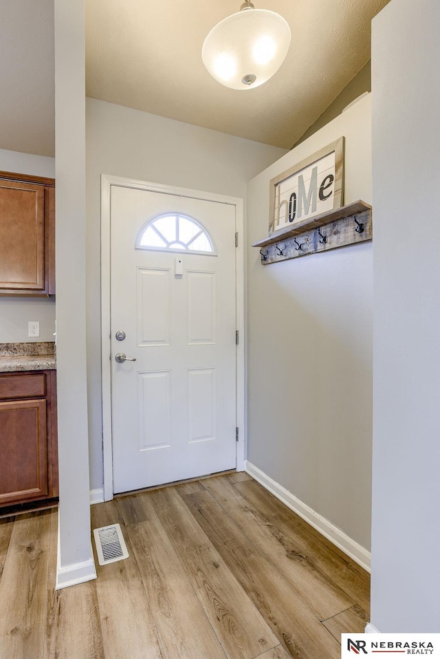 doorway to outside featuring light wood-type flooring